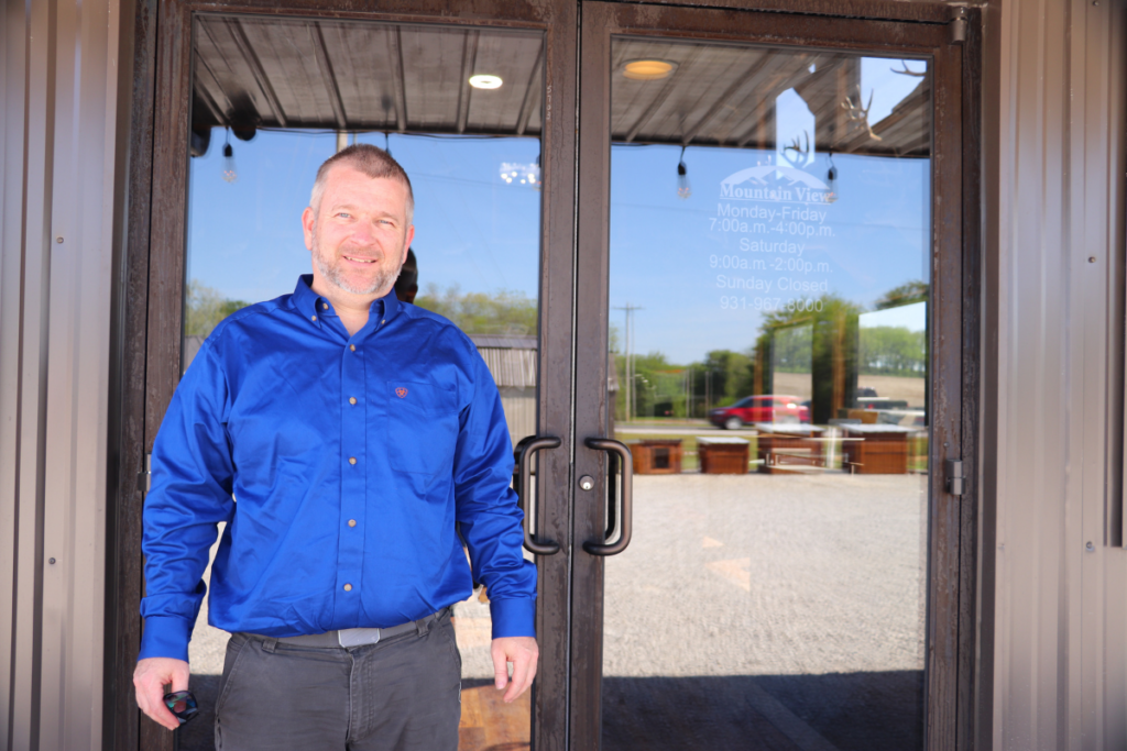 Mountain View owner standing in front of business doors