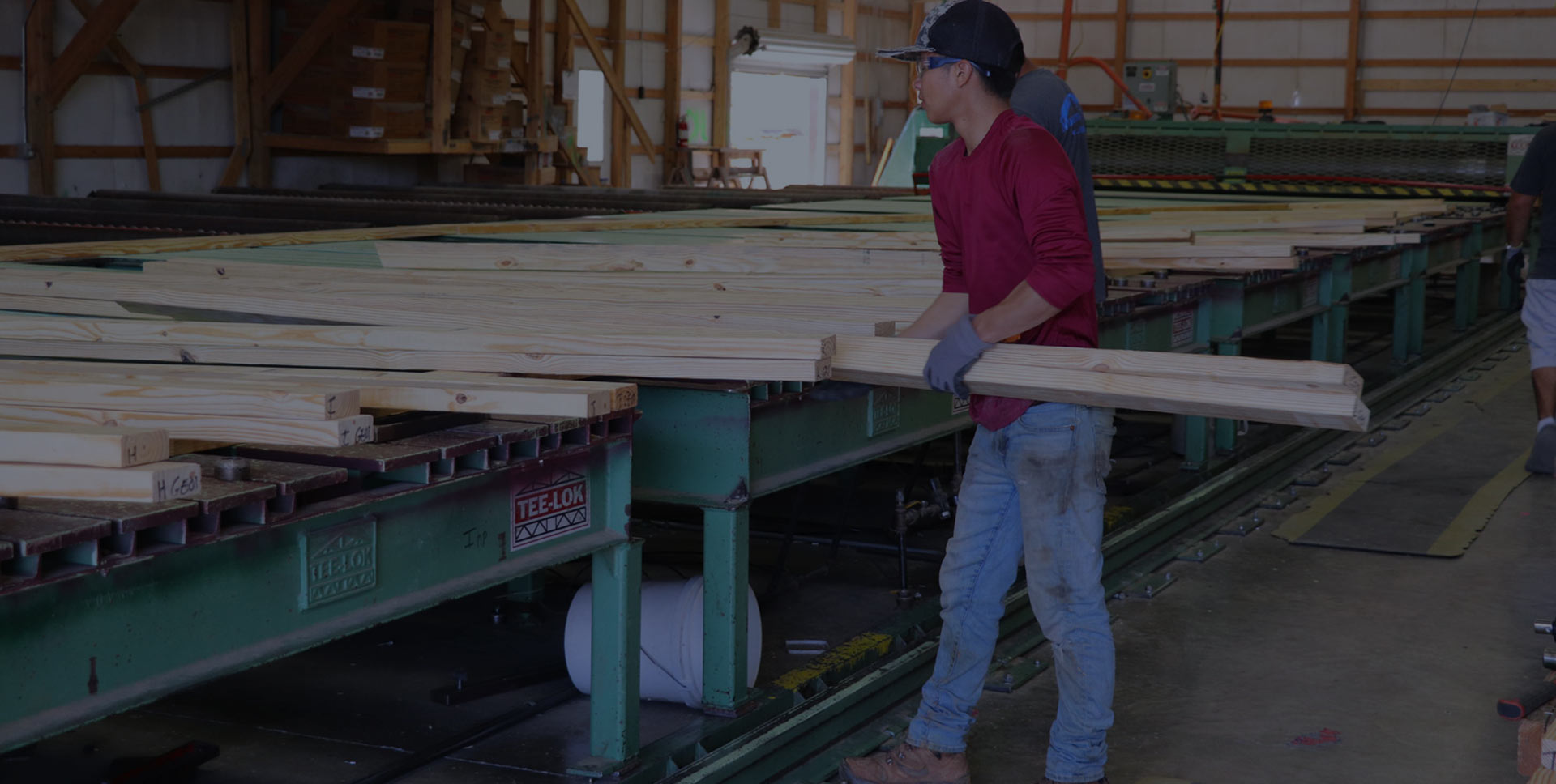 Mountain view lumber employee organizing wood